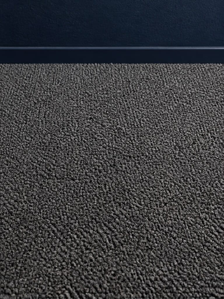 Illustrative close view of charcoal carpet fibers.